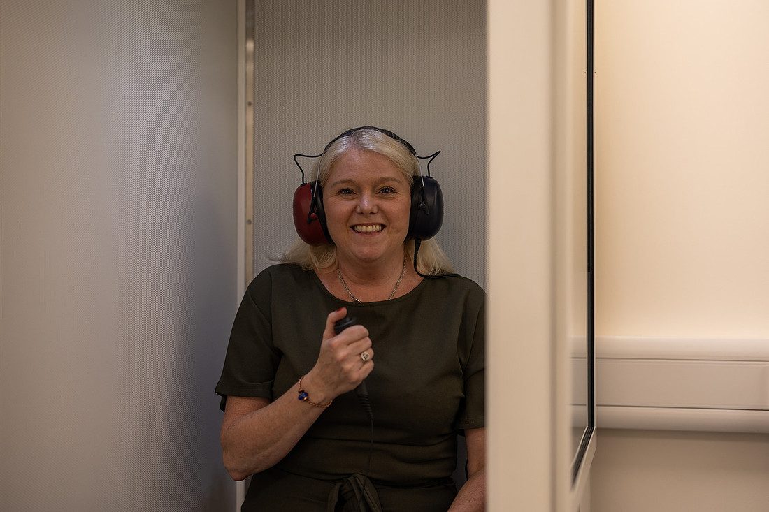 Patient taking a hearing test in a sound-treated booth in Gateshead
